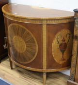 A Sheraton style marquetry inlaid demi-lune side cabinet W.124cm