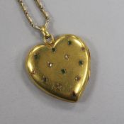 A Victorian yellow metal and gem set heart shaped pendant locket, on a later 9ct gold chain,