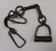 A pair of hand-forged wrought iron slave leg shackles, circa 1800s