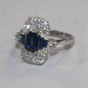 An Art Deco style white metal, sapphire and diamond ring, size M.