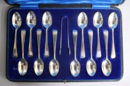A cased set of twelve early 20th century silver teaspoons and pair of sugar tongs, Z.