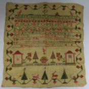 A George IV sampler, unframed, worked in vivid reds, pinks and greens with numbers, alphabets,