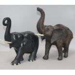 A carved ebony elephant and another