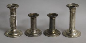 A pair of Victorian silver dwarf candlesticks and a later pair of silver candlesticks, tallest