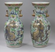 A pair of 19th century Chinese underglaze blue, famille rose celadon ground vases