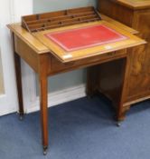 A late Victorian mahogany writing table with hidden stationary compartment W.71cm.