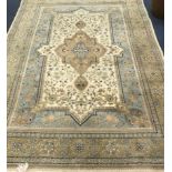 A Persian cream, grey and pale blue carpet 280 x 185cm