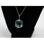 A yellow metal fancy cut aquamarine and diamond set drop pendant, on a yellow metal chain,