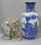 A Chinese blue and white vase and a pair of coloured bisque figures Vase height 46cm (a.f.)