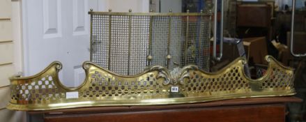 A Victorian pierced brass kerb, a set of 3 fire brasses and a bow fronted guard