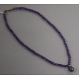 A single strand facetted amethyst bead necklace with Tahitian cultured pearl drop and 9ct gold