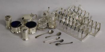 Two pairs of silver toast racks and sundry condiments, including a six-piece set with blue glass