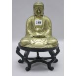 A Chinese brass figure of a seated Buddha, early 20th century, wood stand