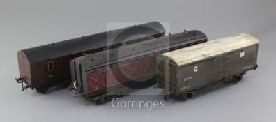 A GW Monster baggage van, no.591, in maroon, an LMS baggage van, no.37817, in maroon and a GW 16T