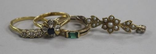 Three 18ct gold and gem set rings and a yellow metal and seed pearl bar brooch.