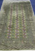 A Bokhara green ground carpet 255cm x 158cm