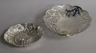 A 1920's pierced silver bonbon dish and a Victorian repousse silver dish by William Comyns, 6 oz.