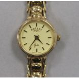 A lady's Rotary 9ct gold manual wind wrist watch, on a 9ct gold bracelet.