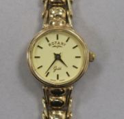 A lady's Rotary 9ct gold manual wind wrist watch, on a 9ct gold bracelet.