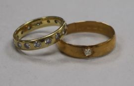An 18ct gold and gypsy set diamond "eternity" ring and a 22ct gold wedding band.