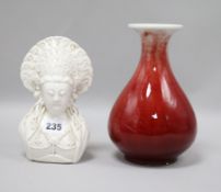 A Chinese blanc de chine bust and a sang-de-boeuf glazed vase 20cm