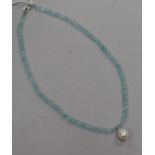 A single strand facetted aquamarine bead necklace, with freshwater pearl drop and 14ct white gold