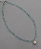 A single strand facetted aquamarine bead necklace, with freshwater pearl drop and 14ct white gold