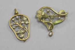 Two yellow metal foliate design pendants.