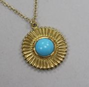 A modern 18ct gold and cabochon turquoise set disc pendant, on a continental yellow metal chain,
