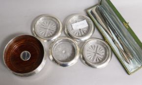 A silver coaster, four others, a cased shoe horn and button hook