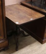 A Regency mahogany tripod table, the rectangular tilting top on a baluster-turned shaft and