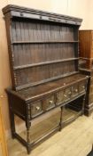 A 17th century style oak dresser W.153cm