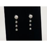 A modern pair of 18ct white gold and diamond cluster and drop earrings, 28mm.