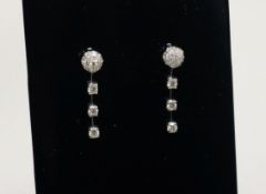 A modern pair of 18ct white gold and diamond cluster and drop earrings, 28mm.