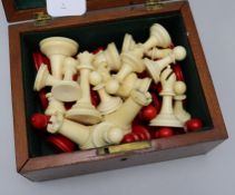 A Staunton ivory chess set, early 20th century, red stained and natural, mahogany box