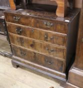 An early 18th Century walnut chest of two short and three long graduated drawers, on bracket feet (