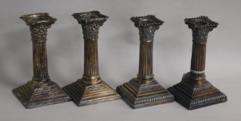 Two pairs of silver corinthian dwarf column candlesticks, tallest 15.5cm.