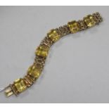 A 1950's 9ct gold and emerald cut citrine set bracelet, 18.7cm approx.