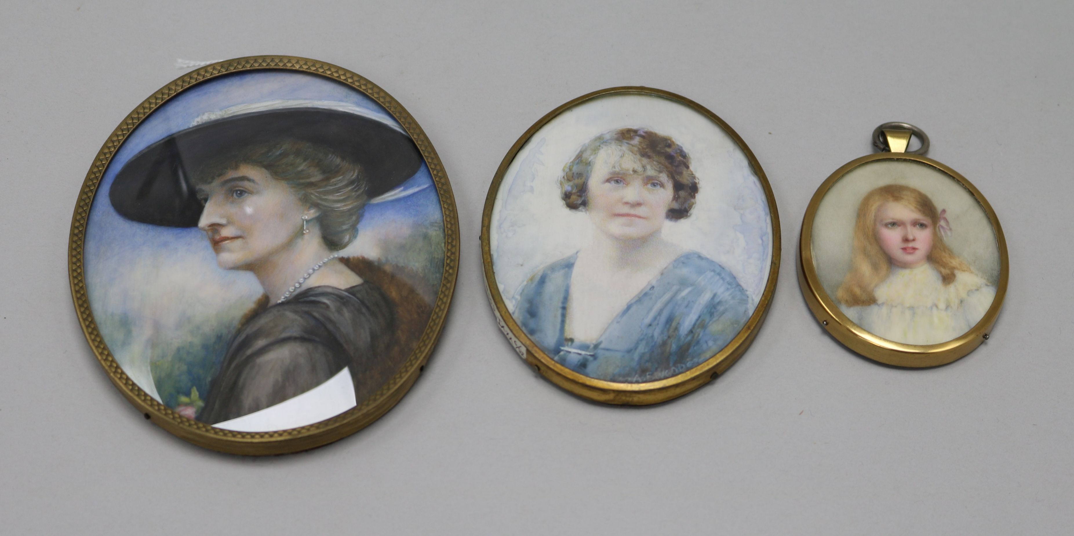 Three early 20thC portrait miniatures on ivory of ladies largest 12 x 9.5cm.