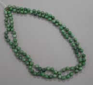 A single strand jadeite bead necklace with 9ct gold clasp, 129cm.