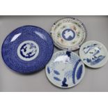 A Japanese blue and white plate, two others, a polychrome plate, a Japanese charger and a cinnabar