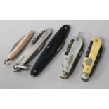 Five folding pocket knives -one silver, one gold faced, three with corkscrews