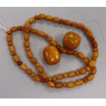 A string of amber beads and two larger loose amber beads, gross weight 78 grams, necklace 78cm.