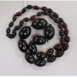 A single strand graduated simulated cherry amber necklace, 70cm, gross 71 grams.