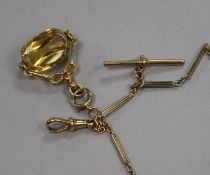 A 9ct gold and citrine fob, on a three colour 9ct gold chain.