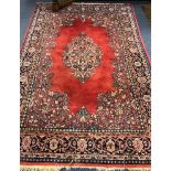 A red ground rug 245 x 165cm