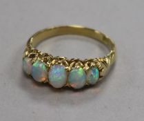 An 18ct gold and graduated five stone white opal half hoop ring, size N.