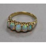 An 18ct gold and graduated five stone white opal half hoop ring, size N.