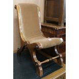 An early walnut Victorian nursing chair, with scrolling padded back and seat