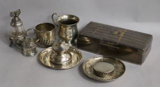 A silver cigarette box, a silver christening mug, a silver cup and saucer, inkwell, condiment and